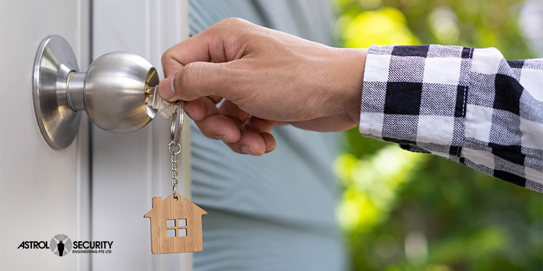 Closeup image of a homeowner locking the front door of their home